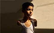 Portrait of Palestinian child without arms wins best news photo of 2025
